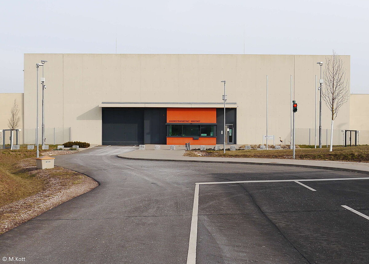 Blick auf die Frontansicht der Jugendstrafanstalt Arnstadt mit Fahrzeug- und Personenschleuse.